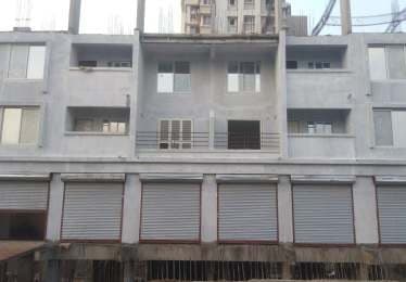 Vaishnavi Palash, a low-rise building with shuttered commercial units below