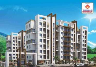 Vaishnavi Vastu, a brown and white apartment building against a bright sky